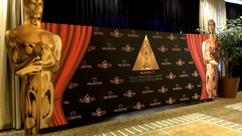 Black step & repeat wall with gold oscar and prudential logos for special event