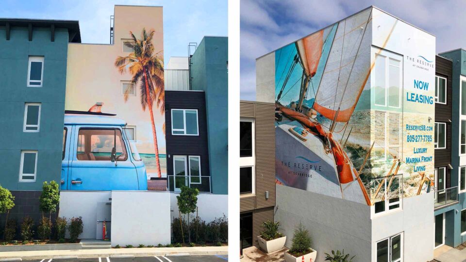 Wall mural on the side of the Reserve Aparament building featuring a blue VW bus and a Sailboat on the ocean