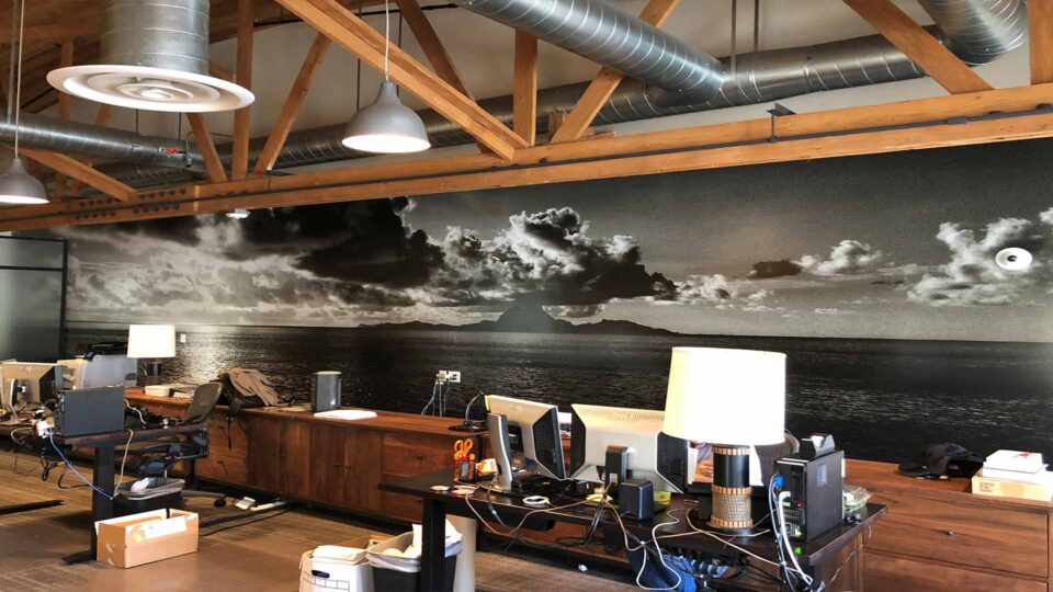 Black and white wall grpahic of ocean, clouds and island for Toms Shoes