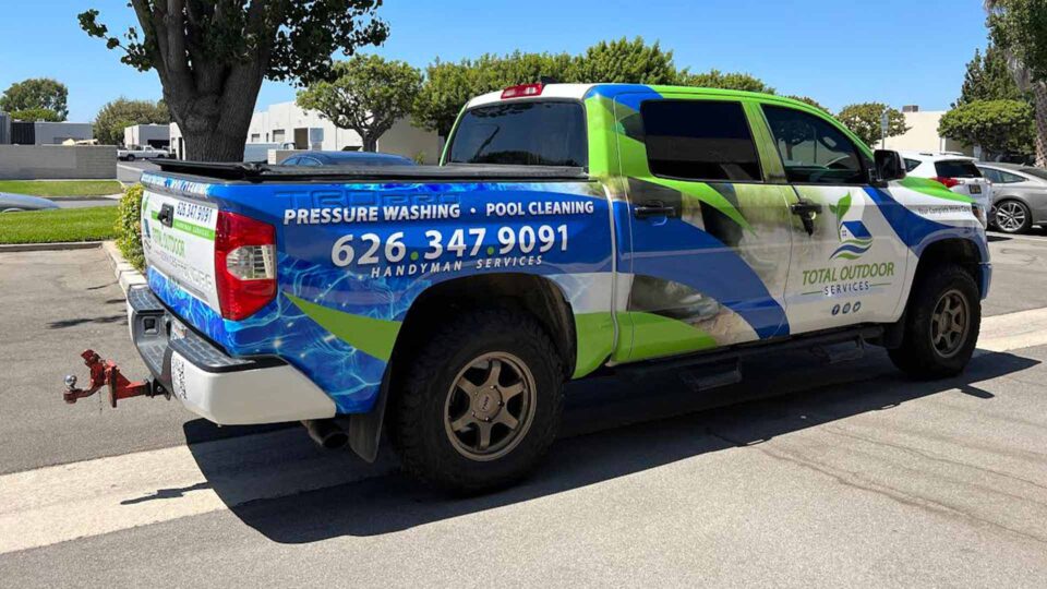 Green, blue and white Tundra Wrap featuring water and cleaning services for Total Outdoor