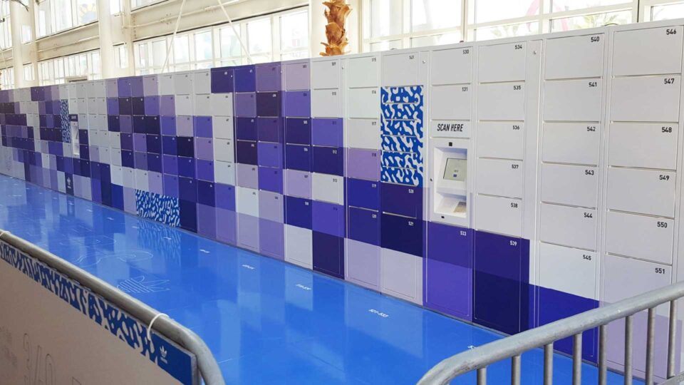 Shades of purple and white square vinyl trade show locker graphics with blue floor.