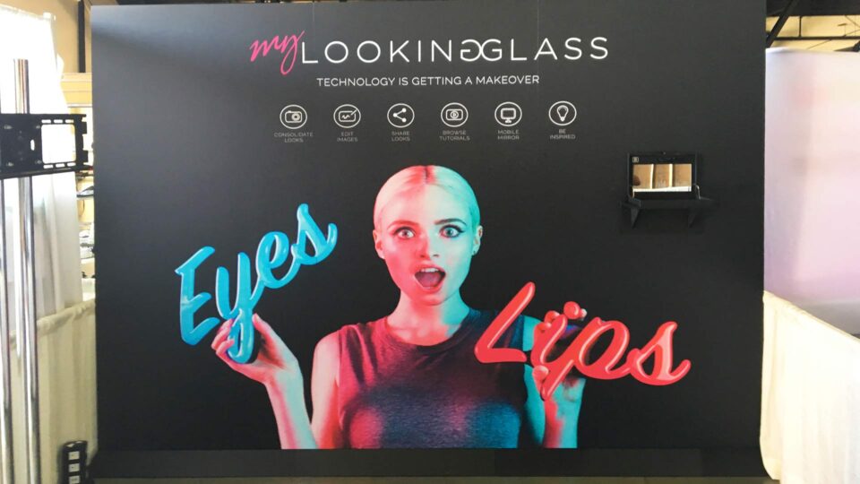Black vinyl wall graphic with model holding words "eyes" and "lips"