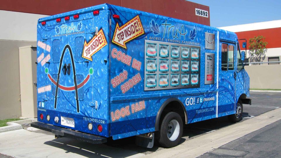 Blue vending truck wrap promoting mobile shoe shopping