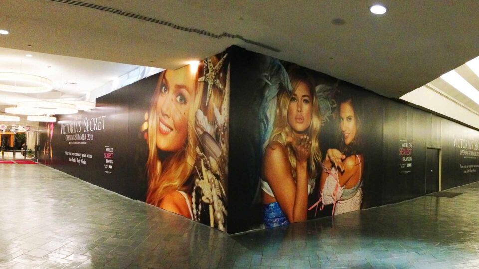 Black background with large images of a few models in lingerie for Victoria's Secret.
