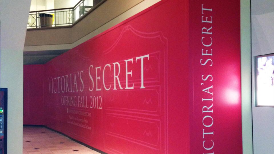 Bright Pink barricade wrap with white lettering for Victoria's Secret in Glendale CA