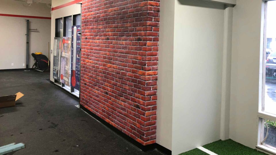 wall graphic of red and white faux brick wall