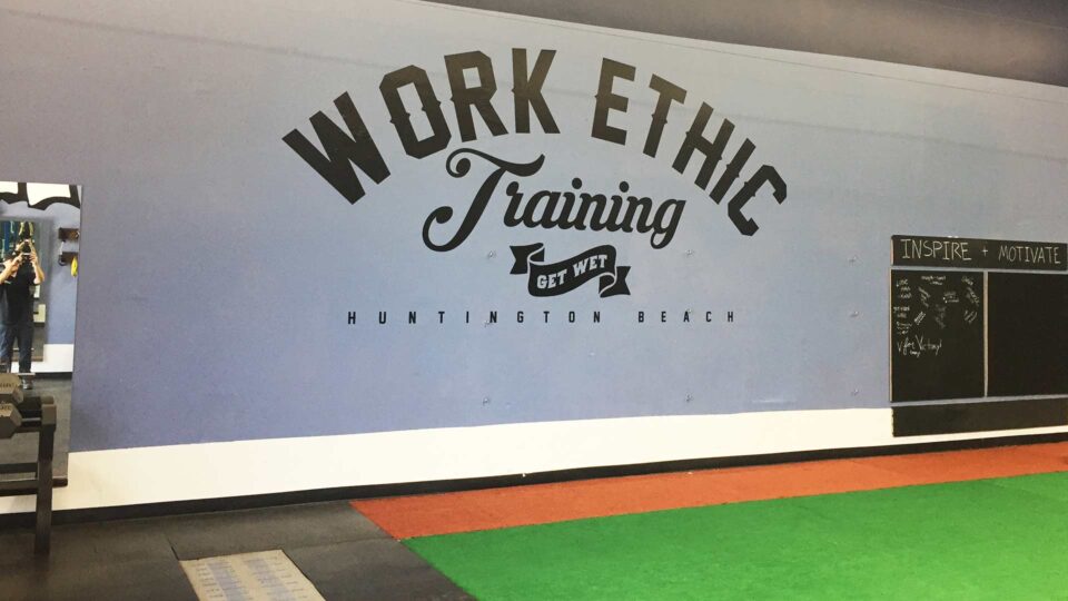 Gray wall with black Die Cut Work Ethic Training die cut logo