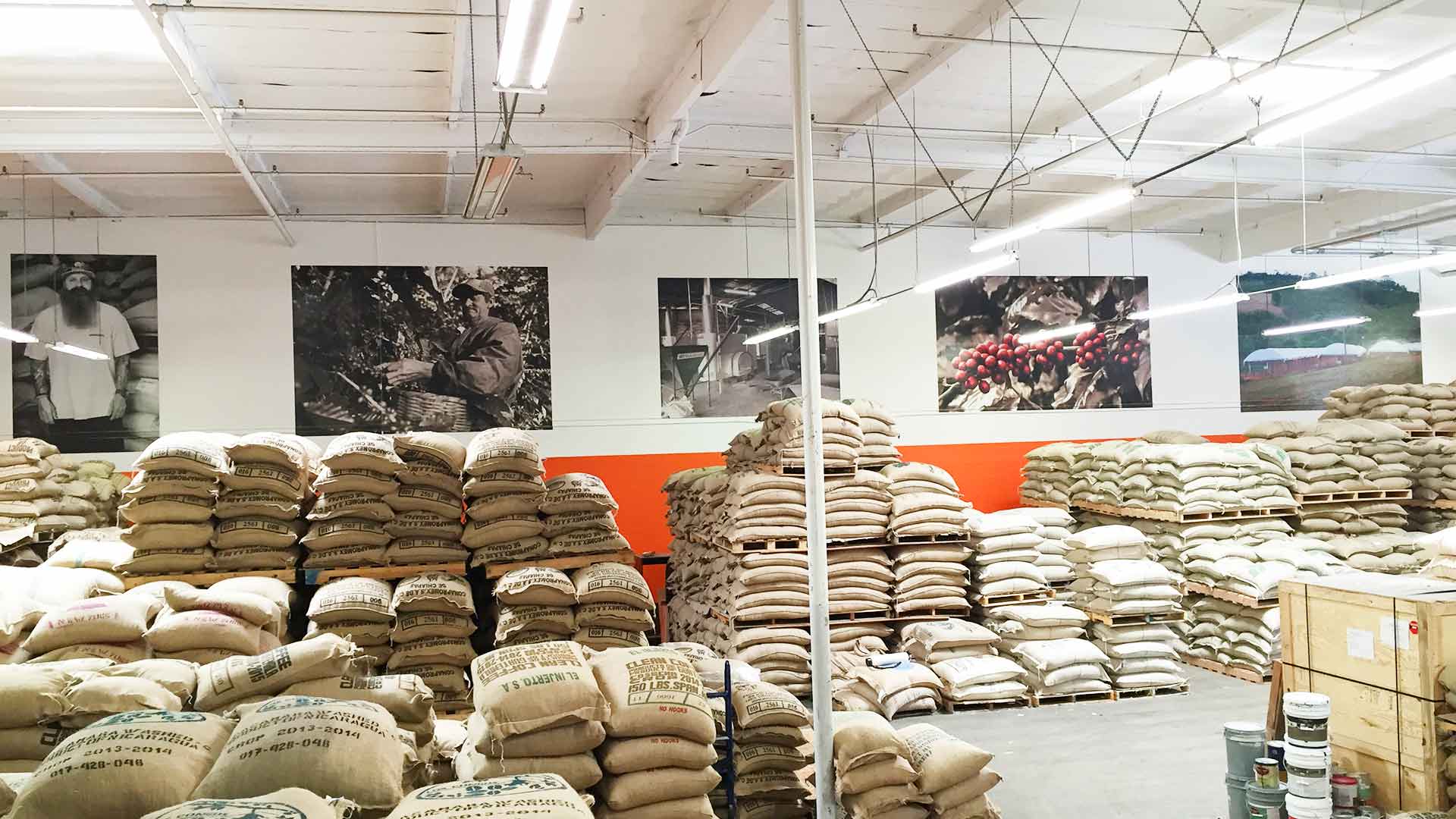 Large wall graphics in a warehouse with burlap coffee bags stacked