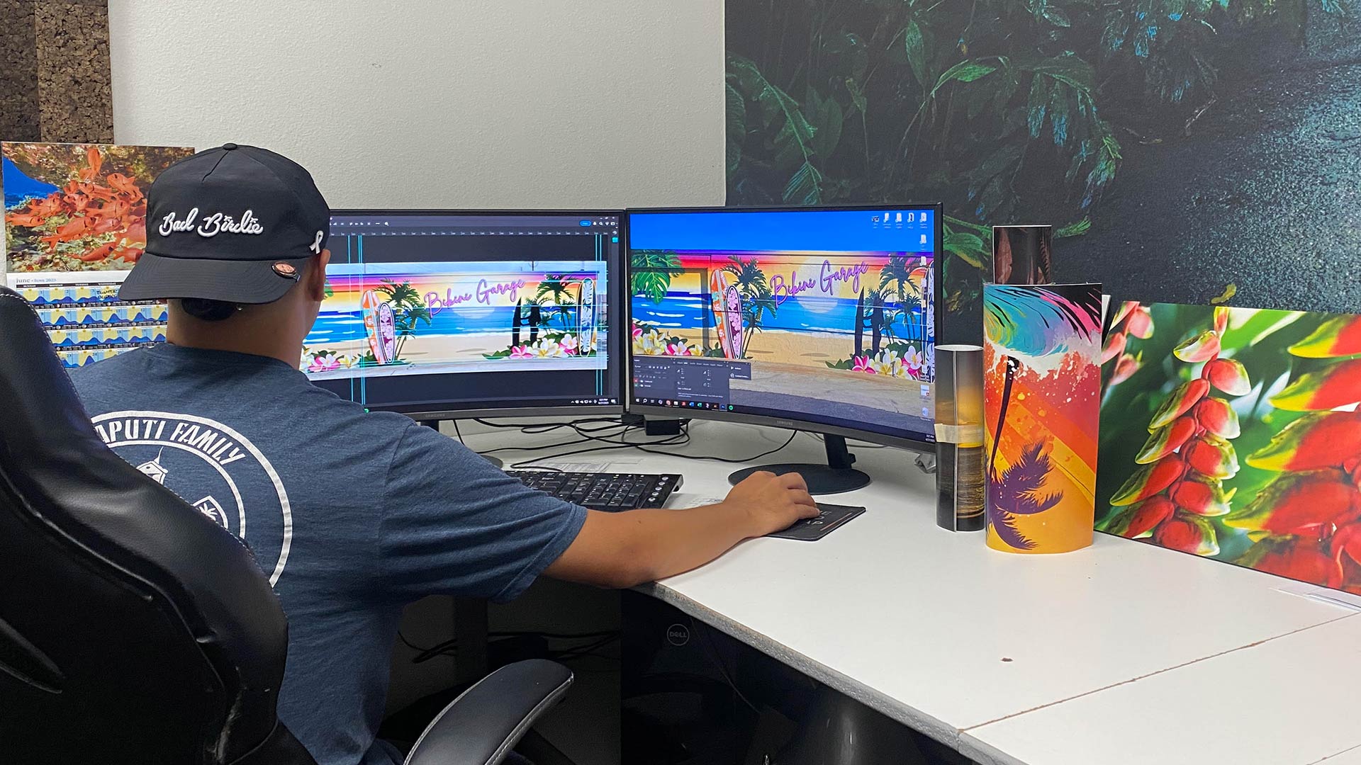 Designer working on graphics displayed on two large monitors
