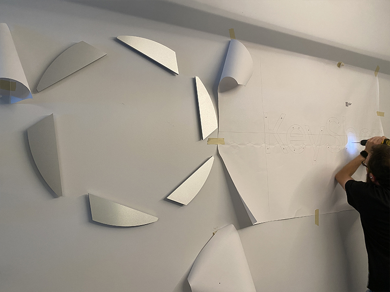 Elevate Your Brand with Custom Raised Letter Signs 4 installation of metal router cut lobby sign