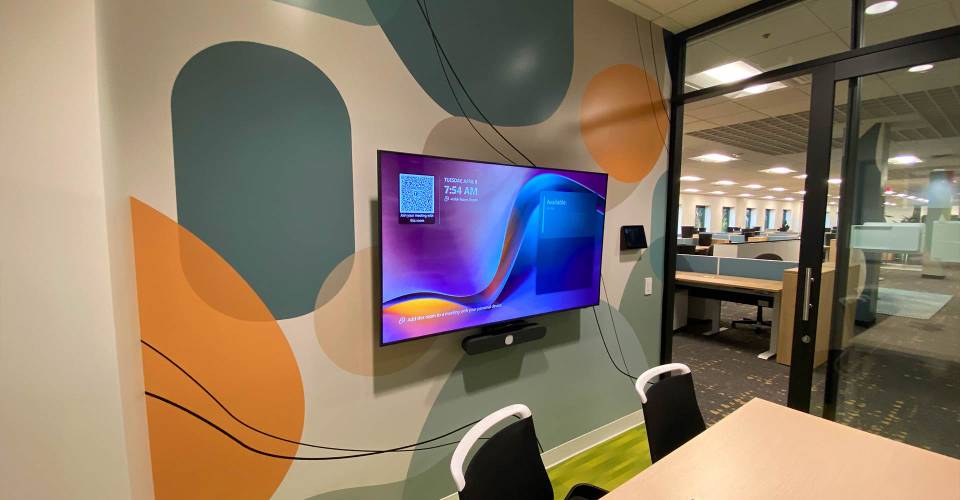 Meeting room with organic shape print on wall with tv