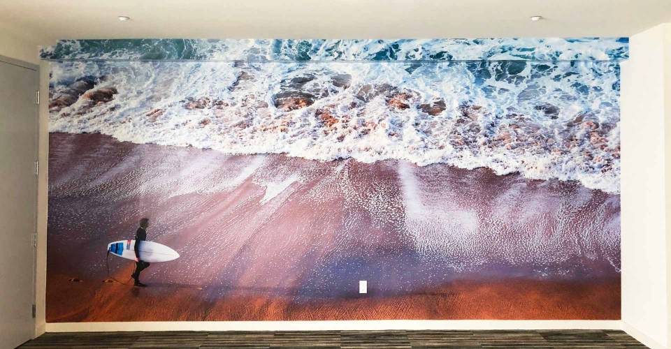 Wall graphic showing waves crashing on a beach