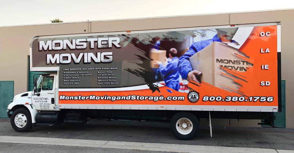 Moving truck with trailer vehicle wrap in gray, white and orange. Features men in blue uniforms moving boxes. White text of logo and services