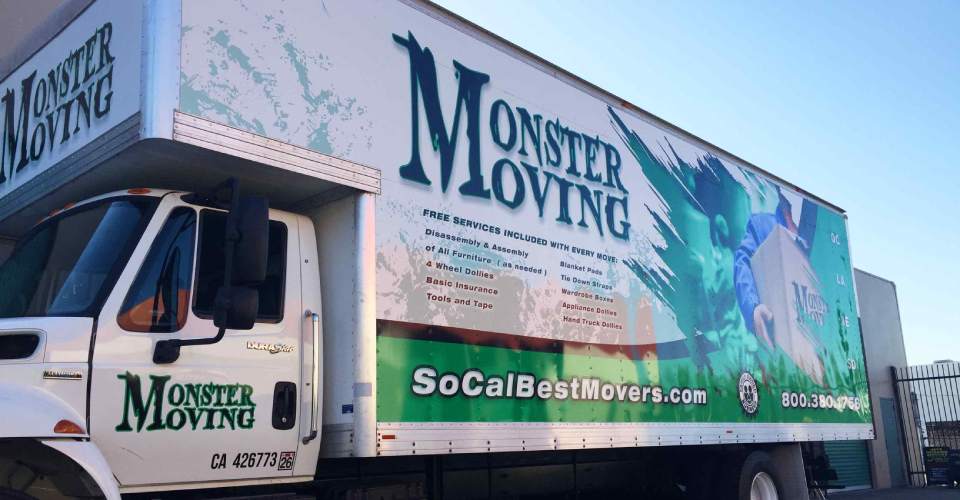Moving truck with trailer vehicle wrap in green, white and black. Features man in blue uniforms moving boxes. text of logo and services