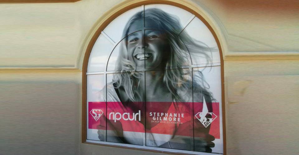 Solid arch window graphics at Rip Curl in San Diego, CA in black and white with image of pro surfer Stephanie Gilmore
