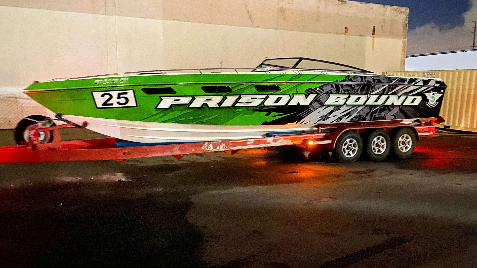 Large offshore racing boat wrap that says Prison Bound with bright green and black colorway